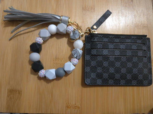 Bracelet with tassel and patterned pouch on a wooden surface