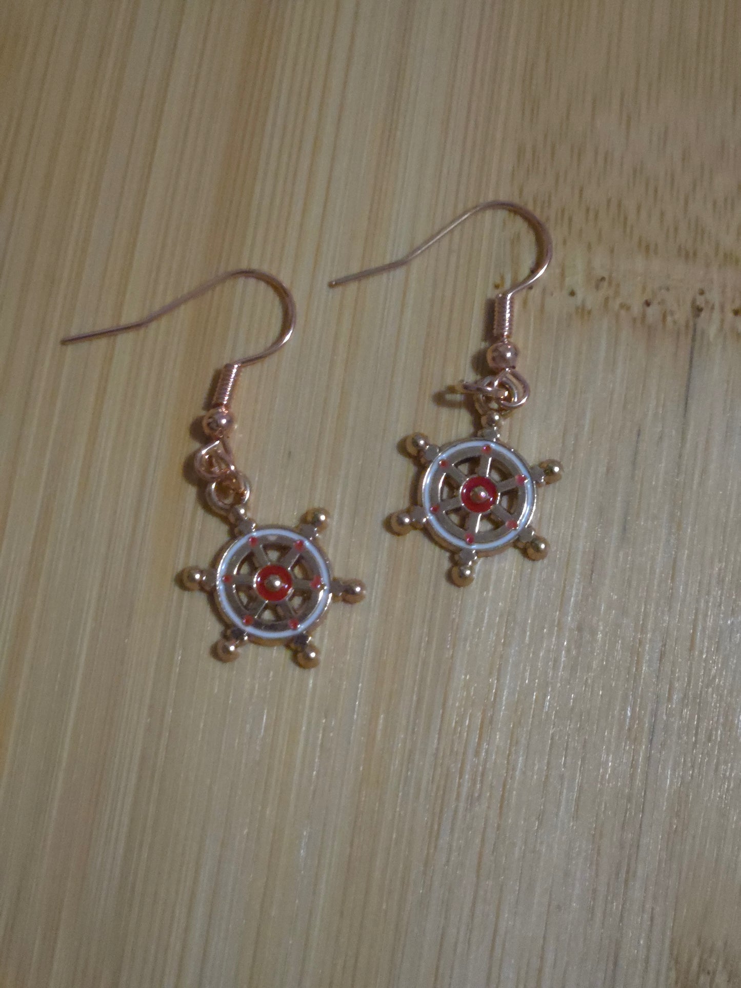Red ship's wheel dangle earrings